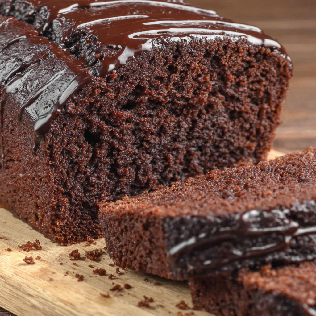 A slice of chocolate cake with chocolate drizzle.