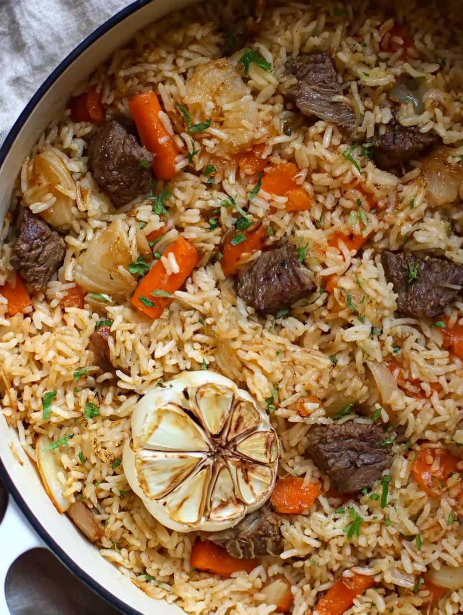A dish of rice with meat and vegetables.