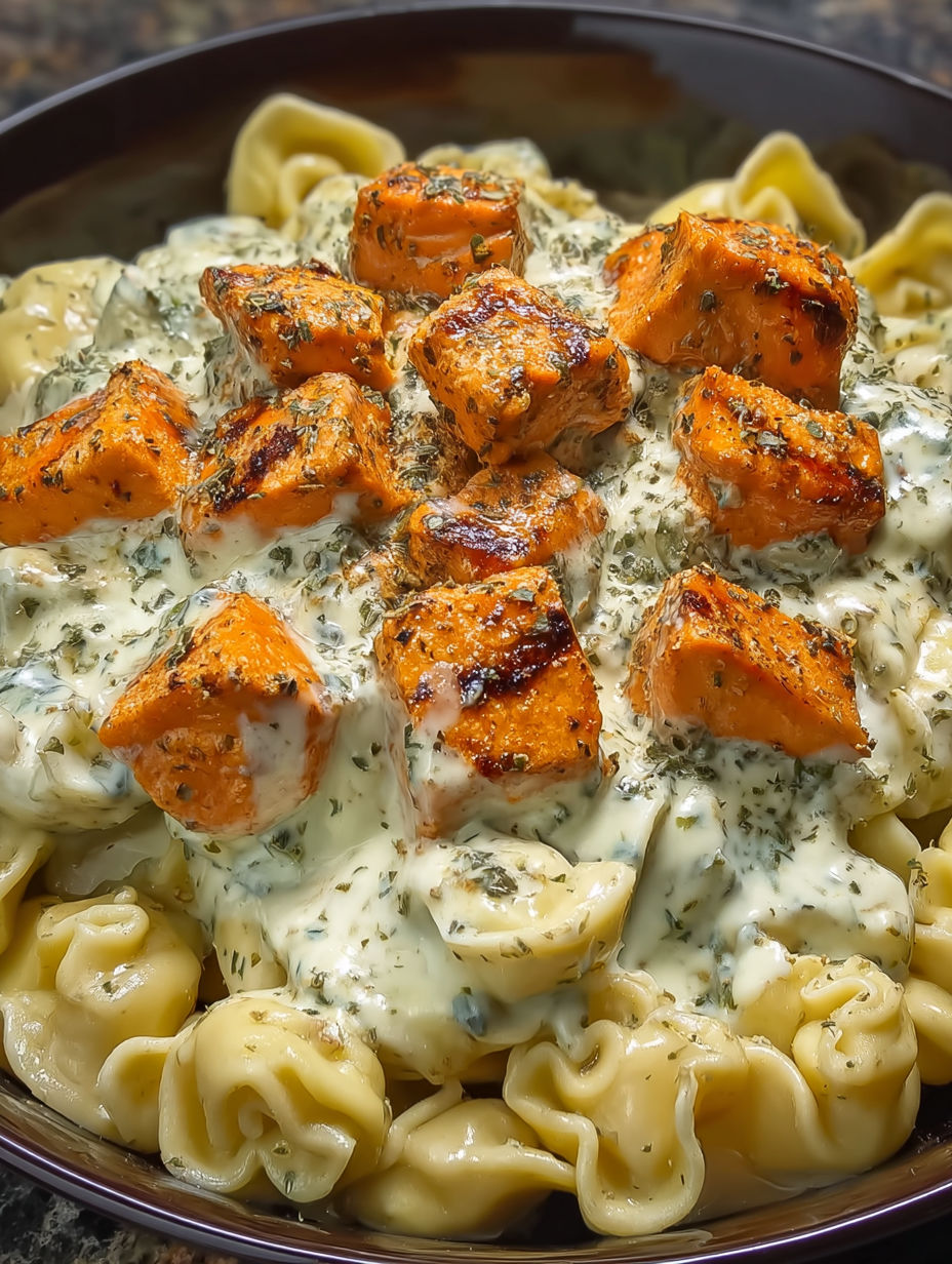 A dish of pasta with chicken and cheese.