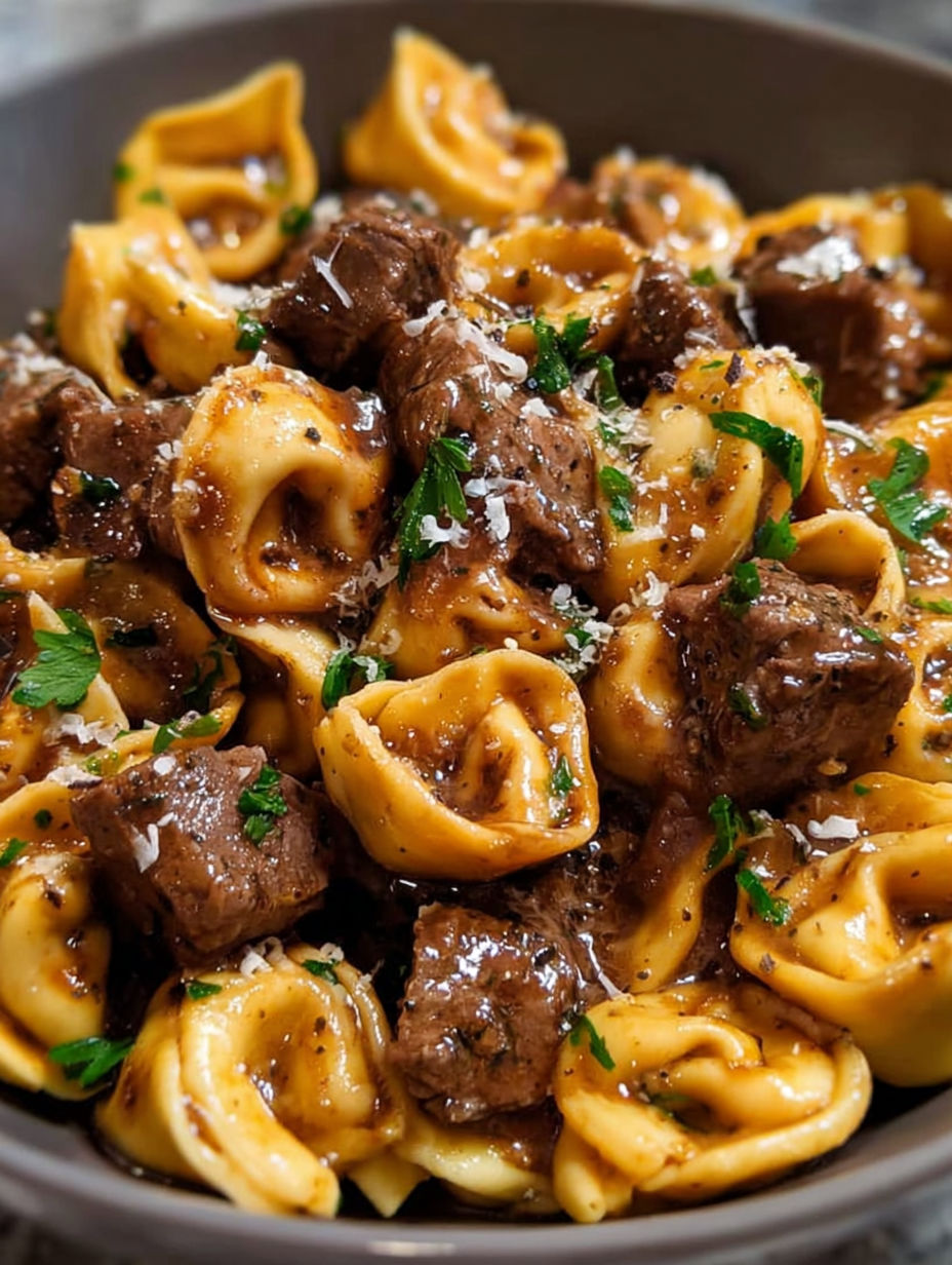 A bowl of pasta with meat and cheese.