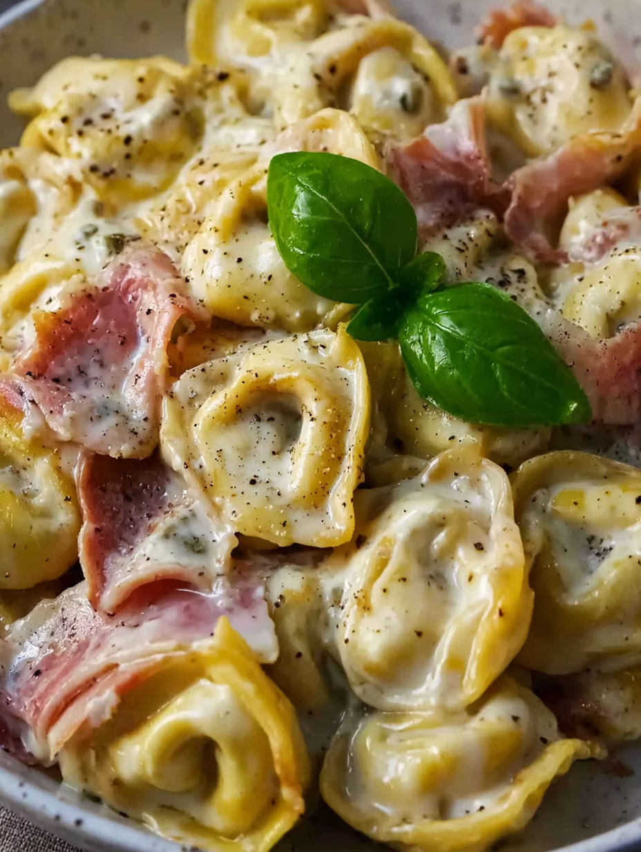 A dish of pasta with cheese and bacon.