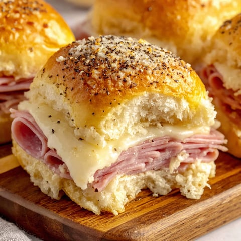 A plate of ham and cheese sliders.