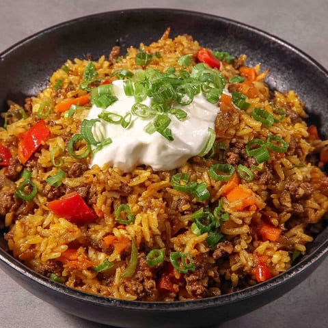 A bowl of curry with meat and vegetables.