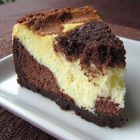 A slice of chocolate cake with white frosting.
