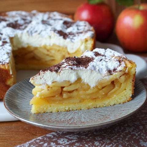 A slice of apple pie with white icing.