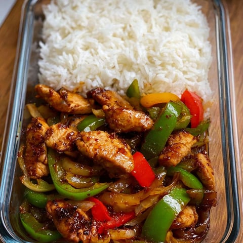 A dish of chicken with peppers and rice.