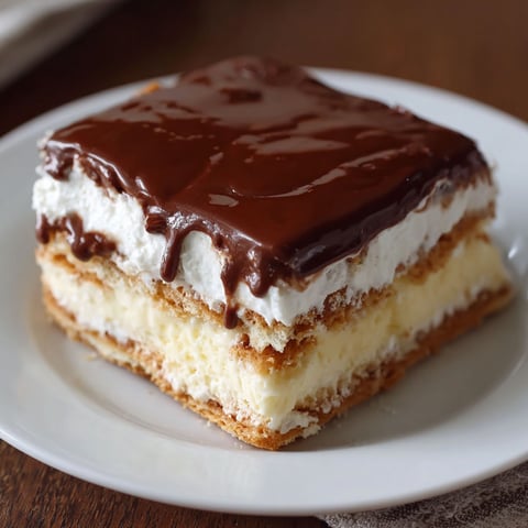 A slice of chocolate cake on a white plate.