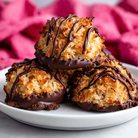 A plate of chocolate covered coconut balls.