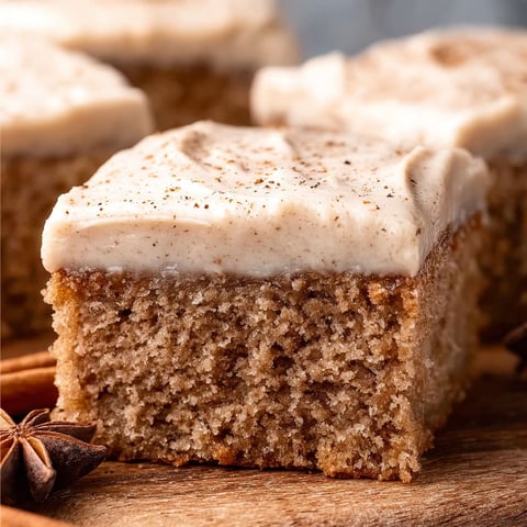 A slice of cake with a white frosting.