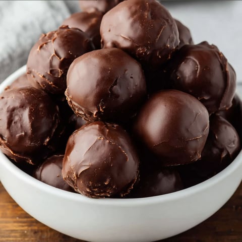 A bowl of chocolate covered rice krispies.