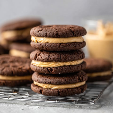 A stack of cookies with peanut butter and jelly in between.