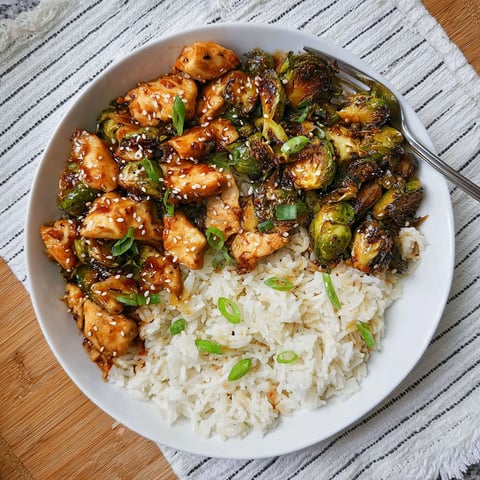 A plate of food with rice and chicken.
