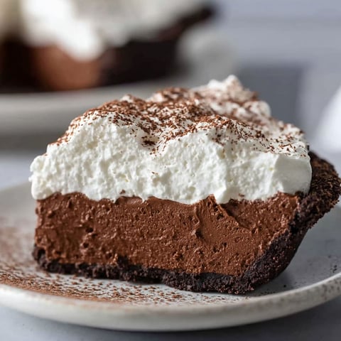 A slice of chocolate cake with white frosting.