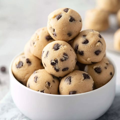 A bowl of chocolate chip cookie dough bites.