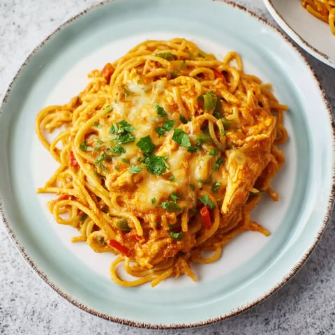 A plate of spaghetti with meat and vegetables.