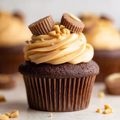 A cupcake with peanut butter and chocolate frosting.