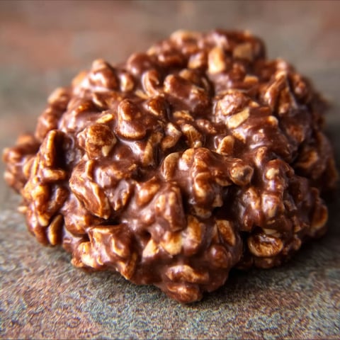 A close up of a cookie with a brown and white color.