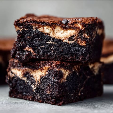 Marshmallow brownies stacked on a table.