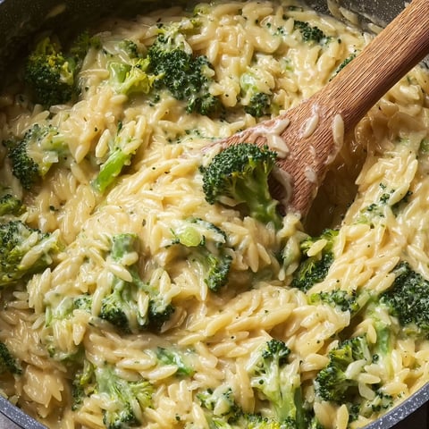 A bowl of broccoli cheddar orzo.
